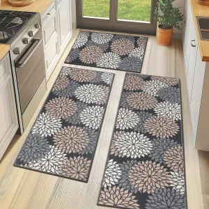 Three geometric-patterned kitchen mats feature a floral design with shades of white, beige, and gray against a dark background, placed on a light wood floor.