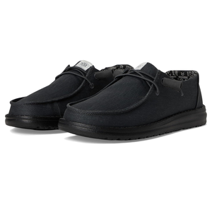 Hey Dude Wally Stretch Canvas Shoes in black feature a relaxed, slip-on style with soft canvas material, leather lace-up design, lightweight sole, and patterned inner lining for comfort.