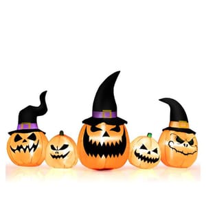 Inflatable Halloween decorations featuring five pumpkins with spooky faces, some wearing witch hats.