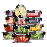 A collection of clear, airtight food storage containers with black latches, filled with assorted fruits and vegetables, including lemons, berries, mangoes, brussels sprouts, strawberries, lychees, and cherry tomatoes.