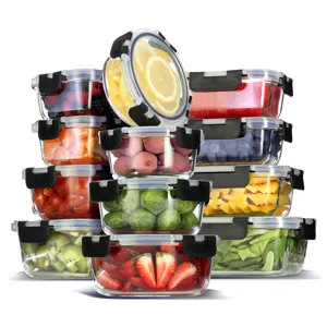 A collection of clear, airtight food storage containers with black latches, filled with assorted fruits and vegetables, including lemons, berries, mangoes, brussels sprouts, strawberries, lychees, and cherry tomatoes.