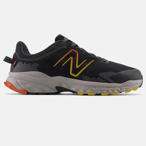 New Balance trail running shoe with a dark upper, prominent 'N' logo in yellow and orange, and a contrasting grey and yellow sole.