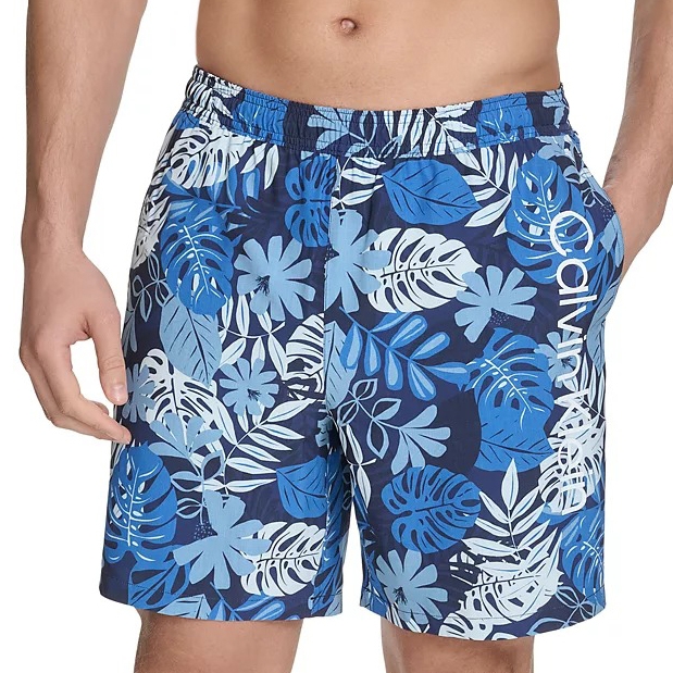 Blue floral-patterned men's swim trunks with an elastic waistband and pockets, featuring various shades of blue leaves and flowers.