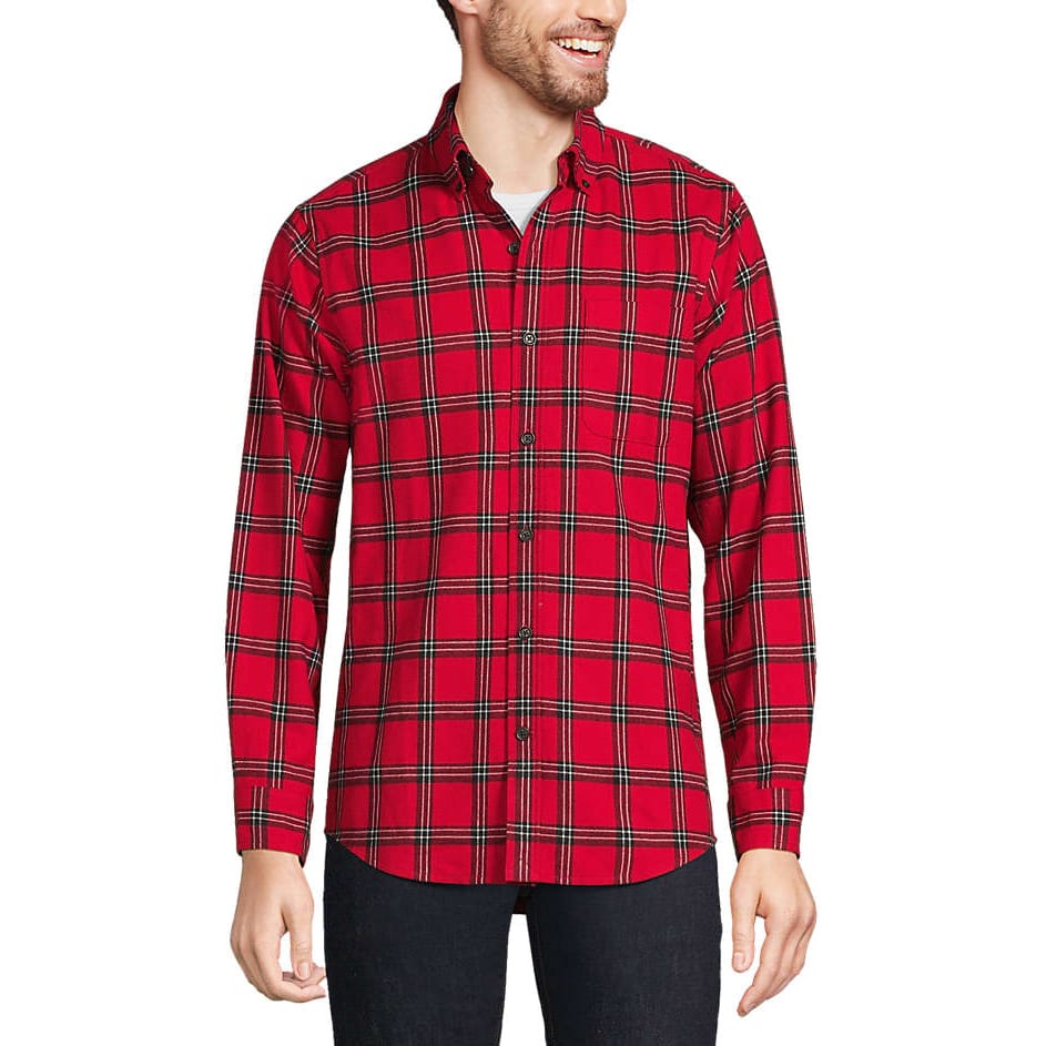 A red plaid button-up flannel shirt with long sleeves, featuring a traditional fit. It's worn over a white undershirt and paired with black pants.