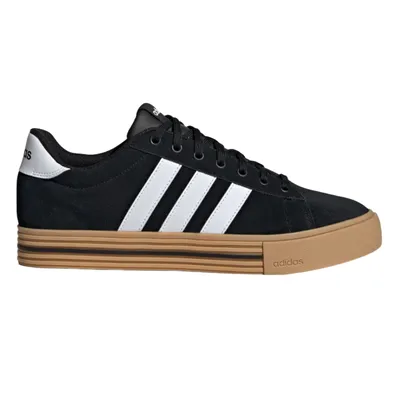 Black and white Adidas sneakers with gum soles and the iconic three stripes on the side.