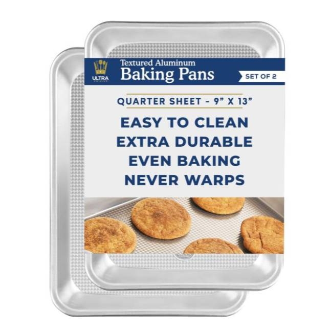 Two textured aluminum baking pans, quarter sheet 9\“ X 13\“, touted as easy to clean, extra durable and warp-resistant. They contain baked cookies for illustration.