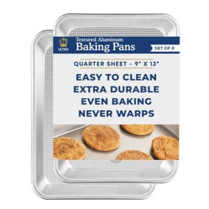 Two textured aluminum baking pans, quarter sheet 9\“ X 13\“, touted as easy to clean, extra durable and warp-resistant. They contain baked cookies for illustration.