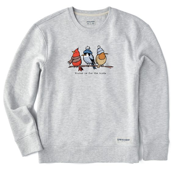A gray fleece sweatshirt featuring a design of three colorful illustrated birds wearing winter hats, with the text \“Winter is for the birds\“ beneath them.
