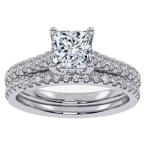 A bridal set featuring a princess-cut diamond at the center with two bands adorned with smaller round diamonds. The design showcases a total weight of 1/2 carat, mounted on a silver-colored metal, likely white gold or platinum.
