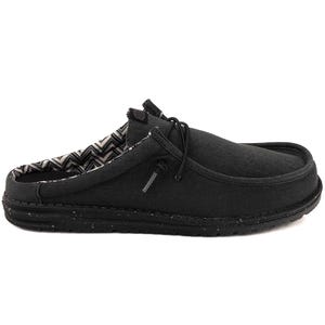 Black slip-on shoe with a speckled sole and a patterned inner lining, featuring lace-up detailing for added style.