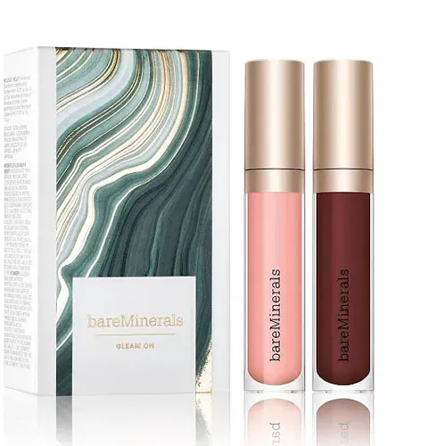 bareMinerals Clean On set with two lip glosses in light pink and burgundy shades, accompanied by a decorative box featuring a swirling green and white design.
