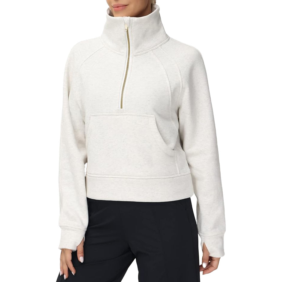 Cream-colored half-zip pullover with high collar, front pocket, and long sleeves made by The Gym People. Features a relaxed fit with slightly ribbed hem and cuffs.