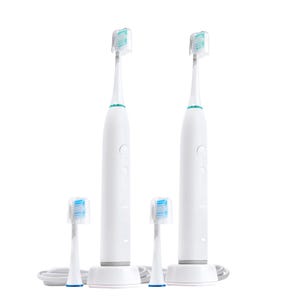 Two electric toothbrushes with their charging base and four replaceable brush heads.