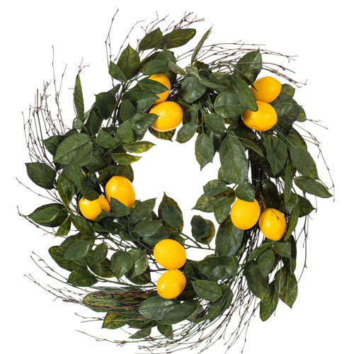 A wreath made of green leaves, small twigs, and several artificial lemons.