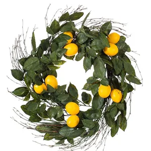 A wreath made of green leaves, small twigs, and several artificial lemons.