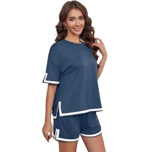 Women's pajamas set features a navy T-shirt and matching shorts, both with white trim accents. The shorts include side slits for added comfort.