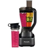 A blender and personal drink container are displayed, filled with a vibrant smoothie and sliced vegetables. The brand logo, \“PowerXL,\“ is visible on the blender base.