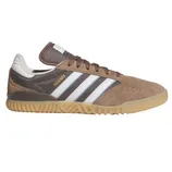 Adidas Busenitz sneaker in brown suede with white and blue stripes, featuring a gum outsole and \“Busenitz\“ branding in gold on the side.