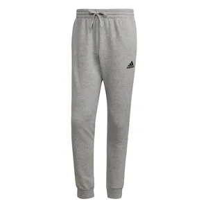 Gray Adidas sweatpants with a drawstring waistband and cuffed ankles, featuring the Adidas logo on the left thigh.