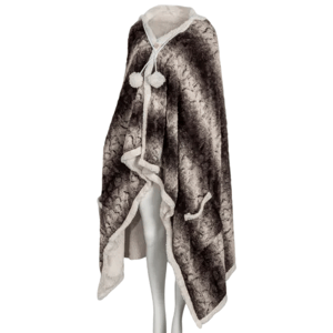 A cozy hooded faux fur cape with a soft, dark patterned exterior and white inner lining, featuring a button closure with pom-pom details.