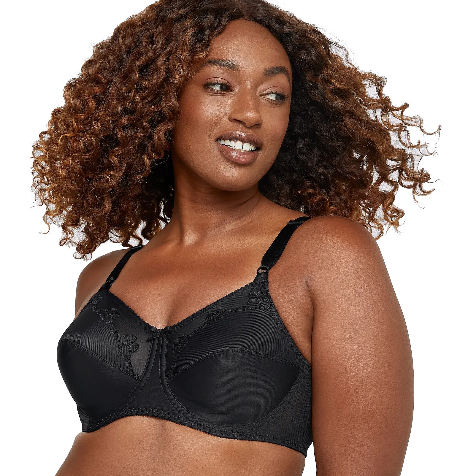 A woman wearing a black, lace-trimmed bra with adjustable straps and an underwire design.