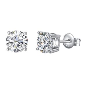 A pair of round-cut diamond stud earrings set in a four-prong silver setting, with screw-back closures.