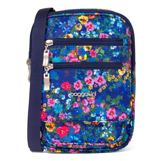 A vibrant Baggallini crossbody bag with a floral pattern on a blue background. It features two front zippered pockets, a front flap pocket, and an adjustable navy strap.