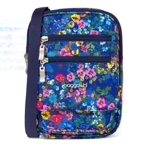 A vibrant Baggallini crossbody bag with a floral pattern on a blue background. It features two front zippered pockets, a front flap pocket, and an adjustable navy strap.