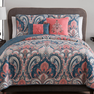 The 5pc VCNY Reversible Queen Quilt Set features a paisley pattern in pink, blue, and gray colors. It includes a quilt, two shams, and two decorative pillows, providing a stylish and coordinated look for a bedroom.