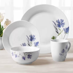 A dinnerware set featuring a dinner plate, salad plate, bowl, and mug, each adorned with delicate blue and purple floral designs on a white background.