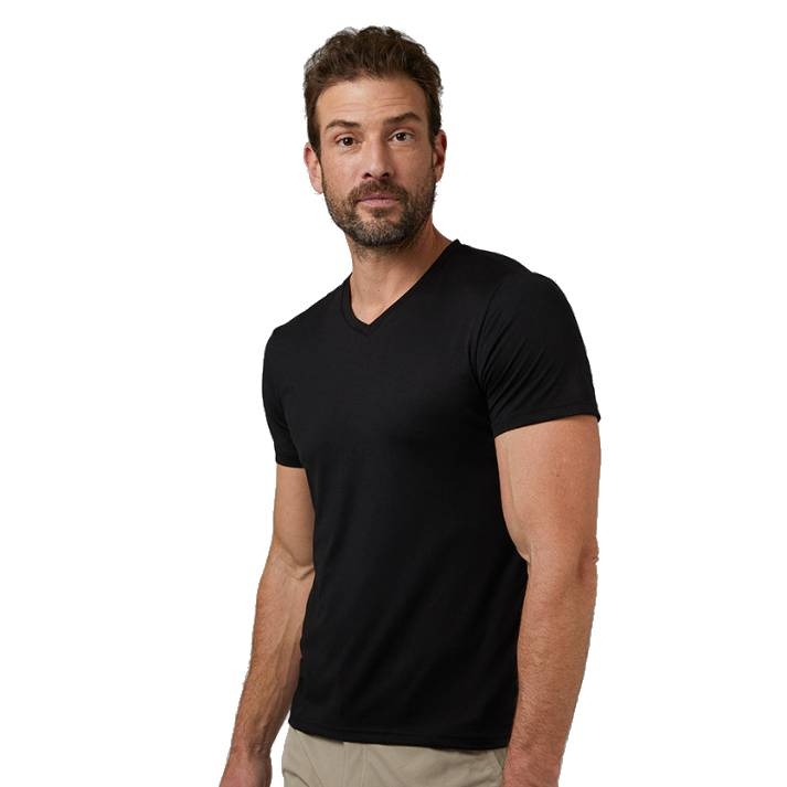 A man is wearing a black V-neck short-sleeved T-shirt, paired with khaki pants.