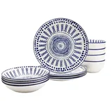 A set of blue and white patterned ceramic dinnerware, including four plates, four bowls, and four mugs. The design features intricate circular and linear patterns.