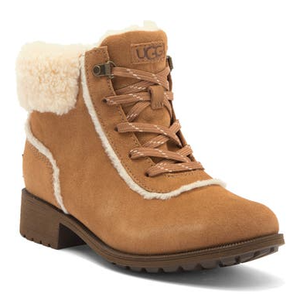 UGG Bodie Faux-Fur Booties feature a tan suede exterior with white faux-fur lining, lace-up front, and a sturdy block heel. Perfect for cold weather, they offer warmth and a stylish look.