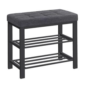 A bench with a cushioned, tufted seat and a black metal frame, featuring dual slatted shelves for storage underneath.
