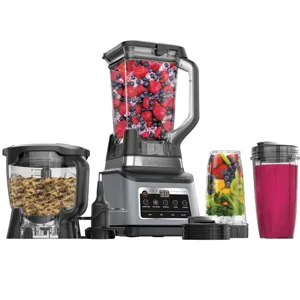 A multi-component kitchen system includes a blender with a pitcher full of berries, a food processor with dough, and a personal blender cup with a pink smoothie and another with mixed fruits and vegetables.