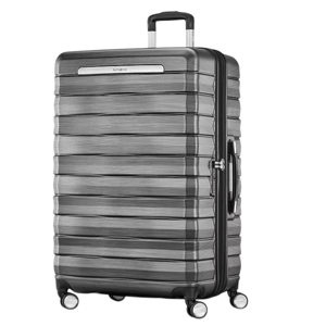 A large hard-shell suitcase with a sleek, textured design, four spinner wheels, and a retractable handle.