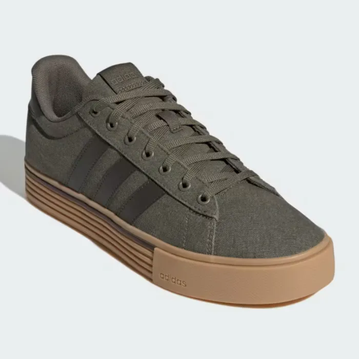 A pair of Adidas sneakers with a grey canvas upper and a brown rubber sole.