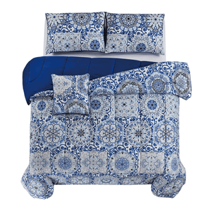 Blue and white bedding set with intricate floral patterns, featuring a comforter, two pillow shams, and a decorative pillow.