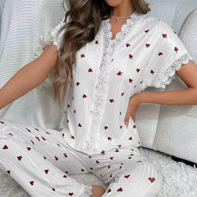 White pajama set with red heart pattern, featuring lace trim on the top and pants.