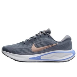 Nike Journey Running Shoes feature a sleek, gray mesh upper with a metallic swoosh, cushioned midsole with blue accents, and a low-profile design for enhanced flexibility and comfort during runs.
