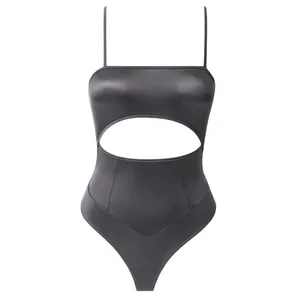 A sleek, black bodysuit featuring thin straps and a prominent cutout across the midsection.