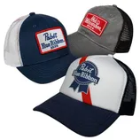 Three trucker hats featuring beer brand logos: two have \“Pabst Blue Ribbon\“ designs in navy and white, and one has \“Old Milwaukee Beer\“ in gray with a red patch.