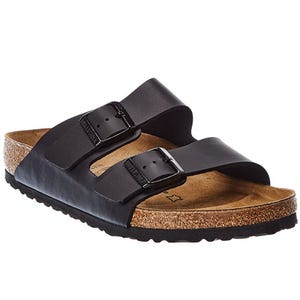 A black sandal with two adjustable straps and buckles, featuring a cork footbed and a textured black outsole, possibly resembling a Birkenstock design.
