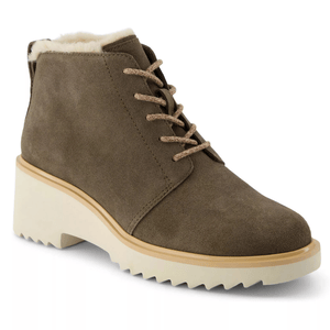 A taupe suede ankle boot with a chunky cream block heel and lace-up design, featuring a soft plush lining.