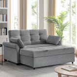 A gray Serta convertible sleeper sofa with a tufted cushion design, adjustable backrest, and one armrest cushion is positioned in a bright room beside a plant.