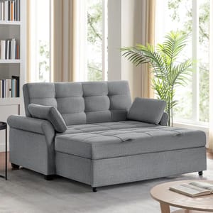 A gray Serta convertible sleeper sofa with a tufted cushion design, adjustable backrest, and one armrest cushion is positioned in a bright room beside a plant.