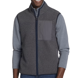 A man is wearing a gray sherpa fleece vest with a zippered front and a contrasting chest pocket over a long-sleeve gray shirt.