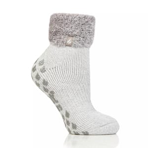 A gray ankle sock with a fluffy cuff and non-slip grip soles, featuring a small tag on the cuff.