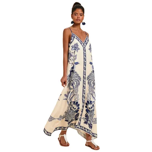 Sleeveless maxi dress with spaghetti straps, featuring a cream base and blue floral patterns, paired with sandals.