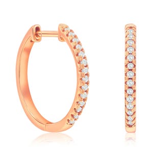 Rose gold hoop earrings adorned with small round diamonds in a pavé setting.